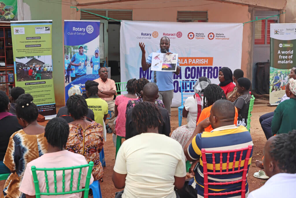 arget Malaria Staff engaging community members on mosquito behaviour.