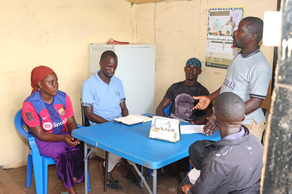Ronald Mbalule talking about the project to community stakeholders at the Target Malaria field office in Lwazi Jaana, Kalangala district.